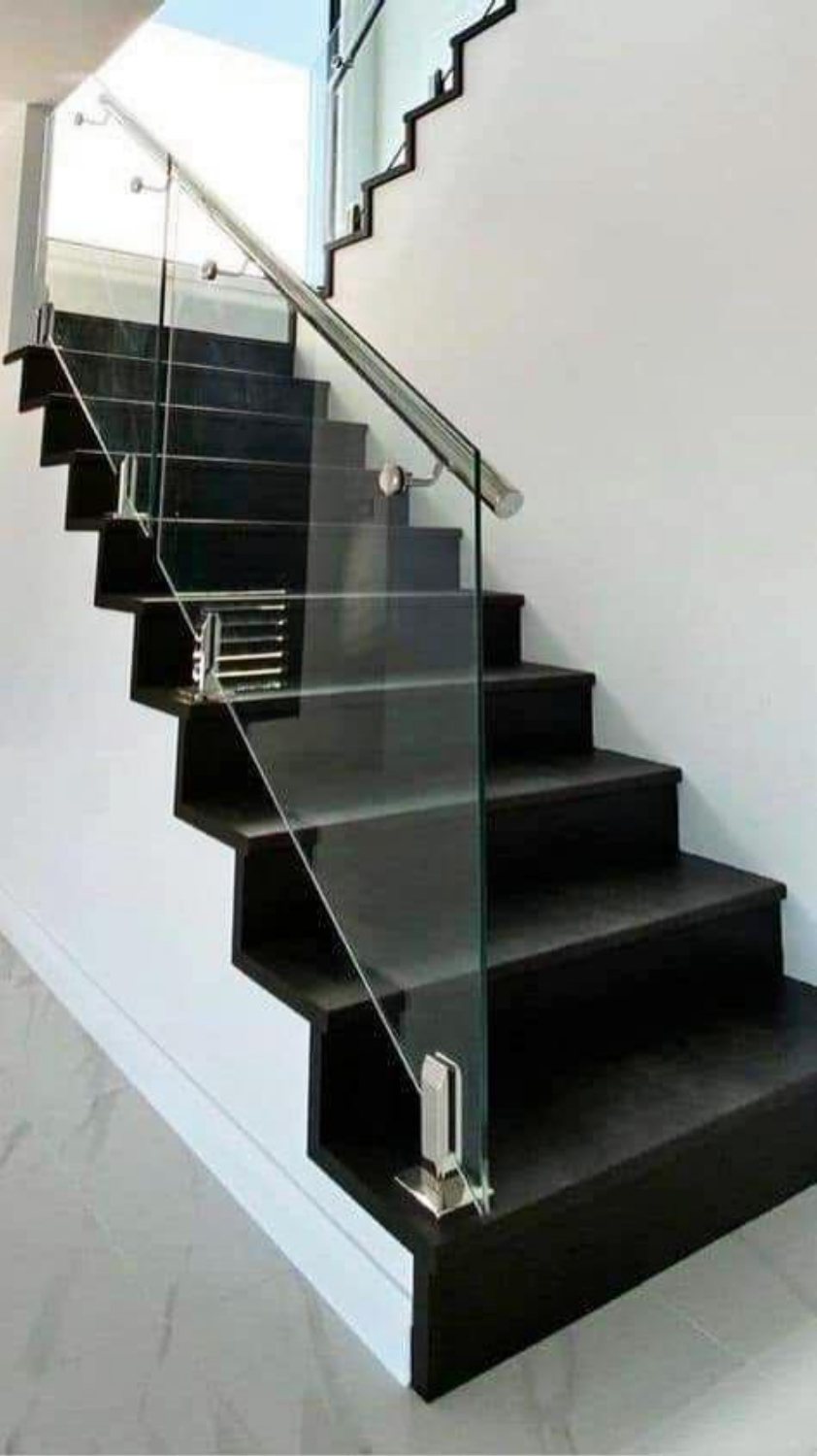 Glass balustrade on black stone stairs