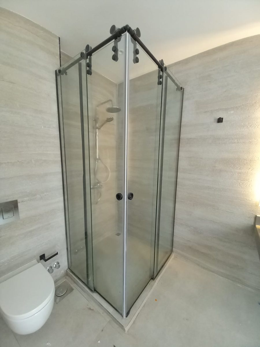Frameless shower enclosure